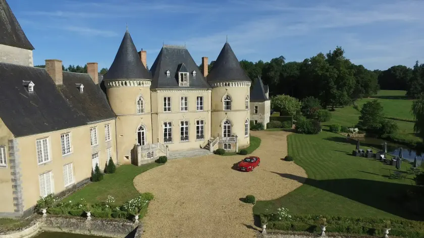 aerial view photography of red vehicle park in front of building